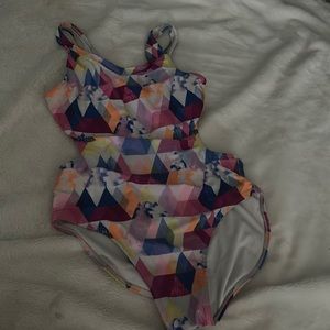 A children’s one piece swimsuit, it has 2 holes, one on each side.